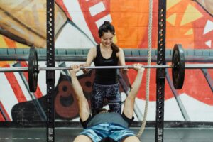 Woman helping bench press