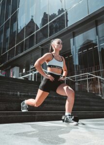 A fit woman doing workouts on city steps in Australia, promoting healthy lifestyle.